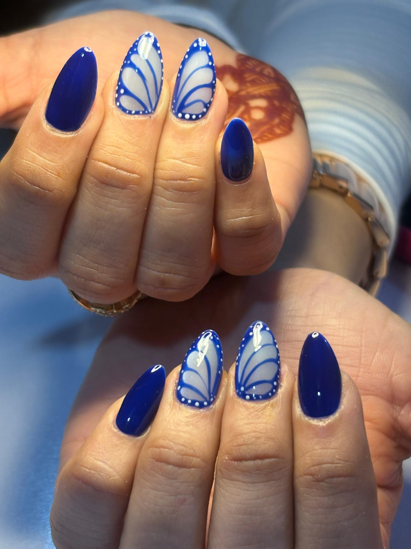 Cobalt blue almond nails with butterfly wing art