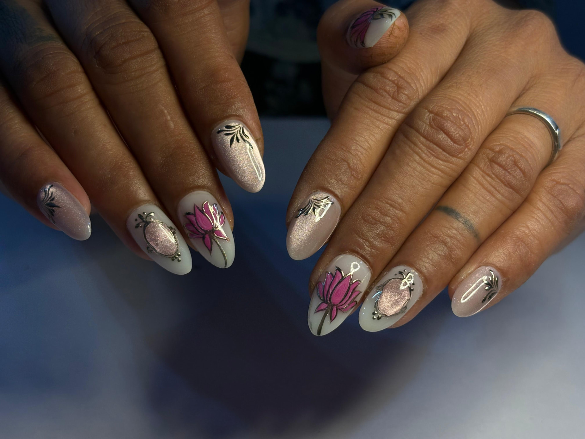Nude shimmer nails with pink lotus and cameo detailing